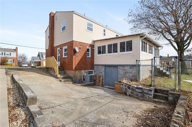 rear view of house featuring cooling unit