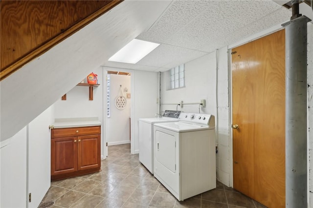 washroom featuring washing machine and dryer and light tile patterned flooring