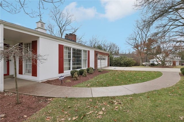 view of property exterior featuring a yard and a garage