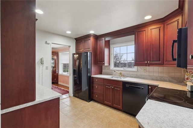 kitchen with sink, a wealth of natural light, decorative backsplash, and black appliances