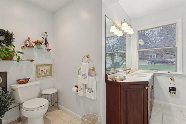 bathroom with tile patterned flooring, vanity, and toilet