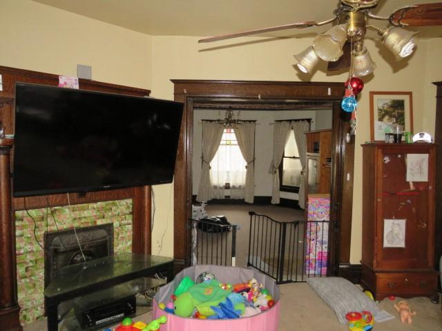 interior space with ceiling fan and carpet flooring