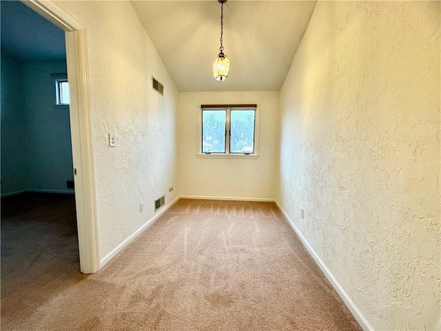 unfurnished room featuring carpet flooring and vaulted ceiling