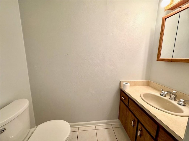 bathroom featuring tile patterned flooring, vanity, and toilet