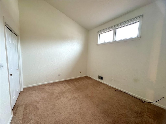 interior space with lofted ceiling and light colored carpet