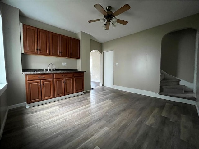 kitchen with ceiling fan, wood-type flooring, and sink