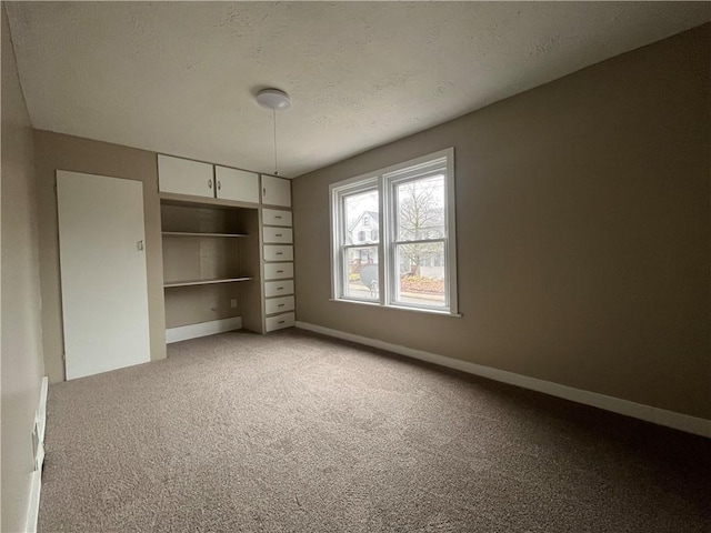 unfurnished bedroom featuring a closet, light carpet, and a textured ceiling