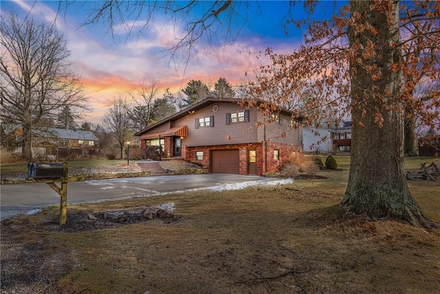 property exterior at dusk featuring a garage and a lawn