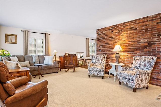 carpeted living room with brick wall