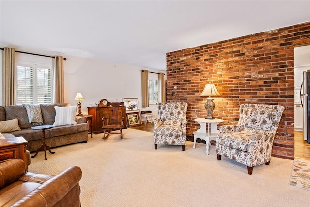 living room with light colored carpet and brick wall