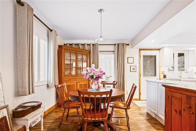 dining room with sink and light wood-type flooring