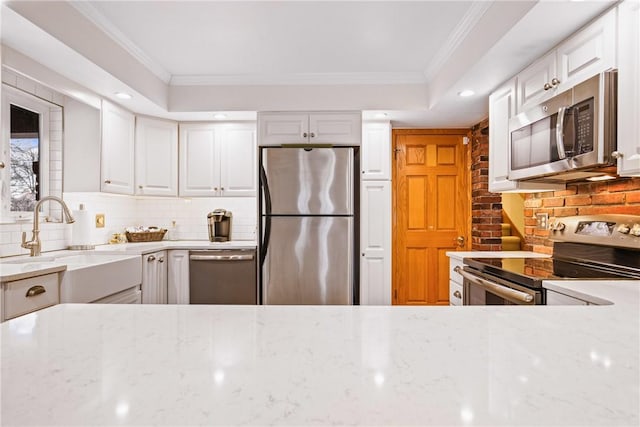 kitchen with white cabinetry, stainless steel appliances, and sink