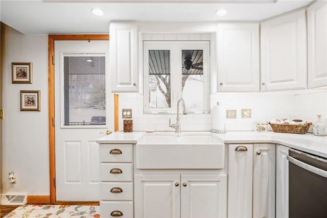 kitchen featuring white cabinetry, sink, decorative backsplash, and dishwasher