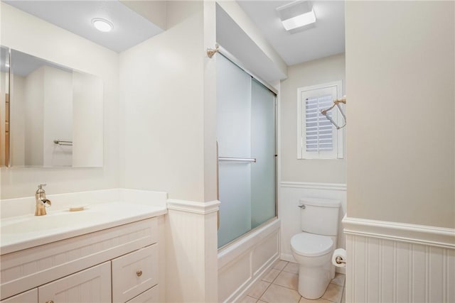 full bathroom with vanity, tile patterned floors, toilet, and combined bath / shower with glass door