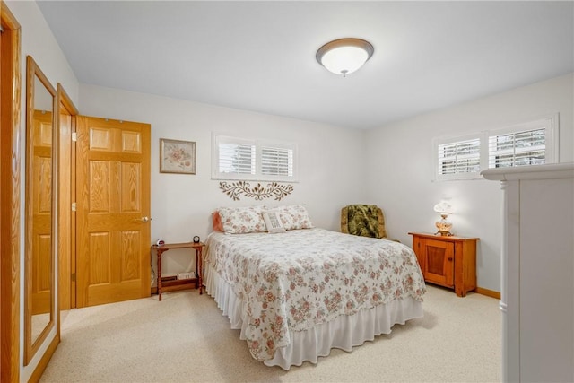 bedroom featuring light colored carpet