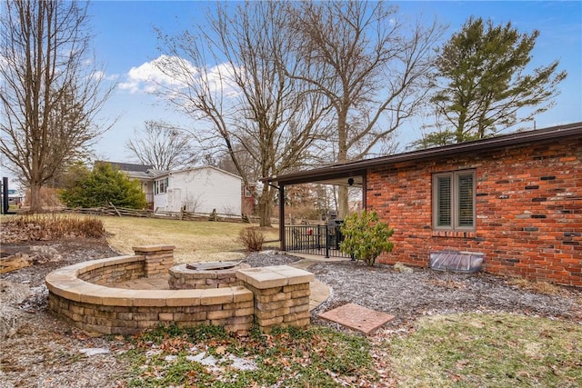 view of yard with a fire pit