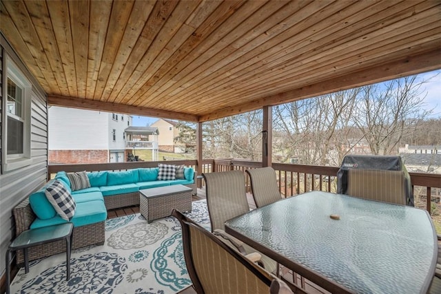 wooden terrace with grilling area and outdoor lounge area