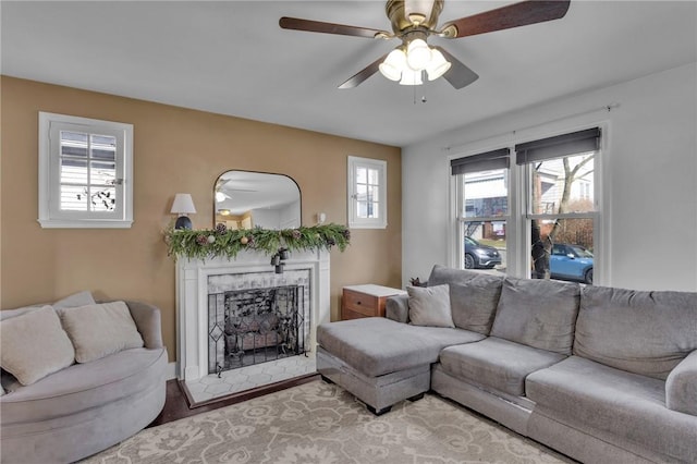 living room with light hardwood / wood-style flooring and ceiling fan