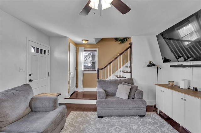 living room featuring wood-type flooring and ceiling fan