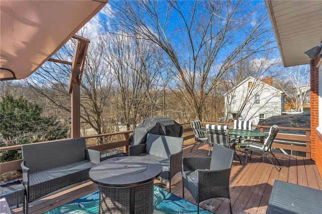 wooden deck featuring area for grilling and an outdoor living space