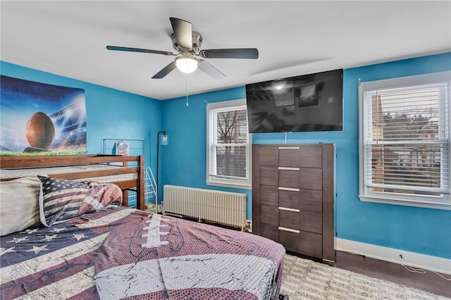 bedroom featuring ceiling fan and radiator