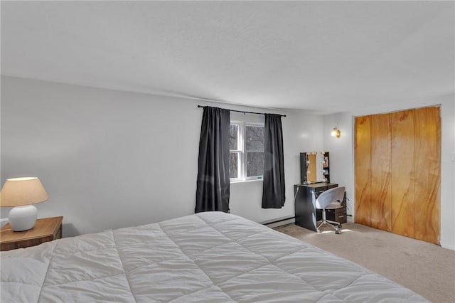 bedroom with baseboard heating and light colored carpet