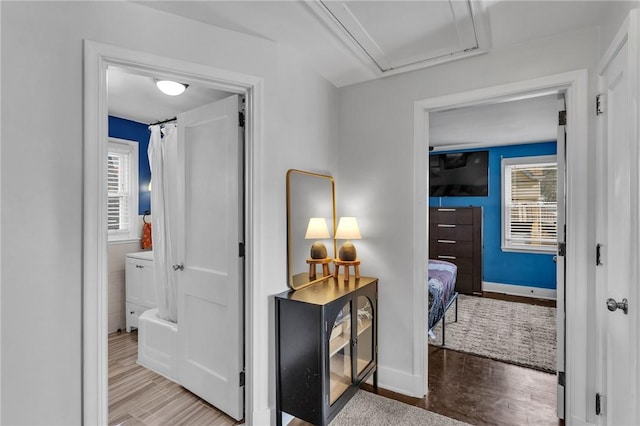 corridor with hardwood / wood-style floors