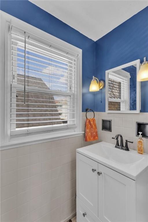 bathroom with vanity and tile walls