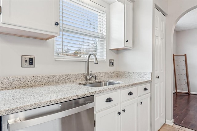 530 Peregrine Dr, North Huntingdon, PA 15642 - kitchen with light stone counters, arched walkways, a sink, white cabinets, and dishwasher