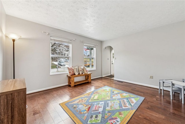 530 Peregrine Dr, North Huntingdon, PA 15642 - sitting room with baseboards, arched walkways, a textured ceiling, and wood finished floors
