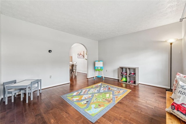 530 Peregrine Dr, North Huntingdon, PA 15642 - rec room featuring hardwood / wood-style floors, arched walkways, and a textured ceiling