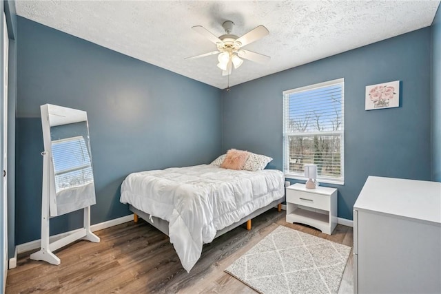 530 Peregrine Dr, North Huntingdon, PA 15642 - bedroom with ceiling fan, baseboards, a textured ceiling, and wood finished floors