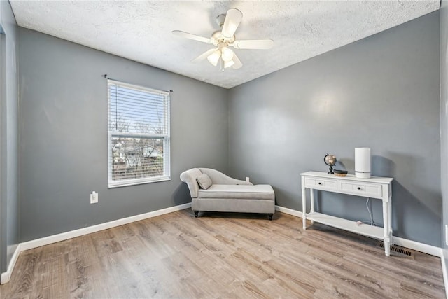 530 Peregrine Dr, North Huntingdon, PA 15642 - living area featuring baseboards, a textured ceiling, and wood finished floors