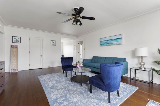 living room with ornamental molding, ceiling fan, and dark hardwood / wood-style flooring