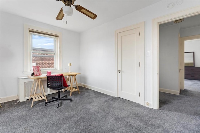 office space featuring radiator, ceiling fan, and dark colored carpet