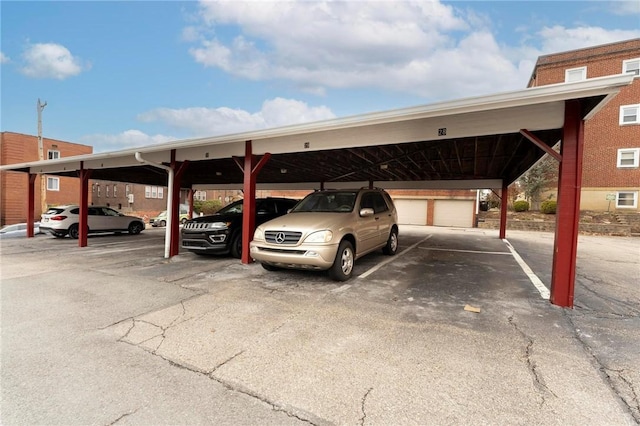 view of vehicle parking with a garage and a carport