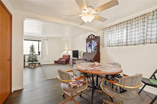 dining area with dark hardwood / wood-style floors and ceiling fan