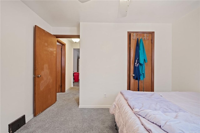 bedroom with light carpet and a closet