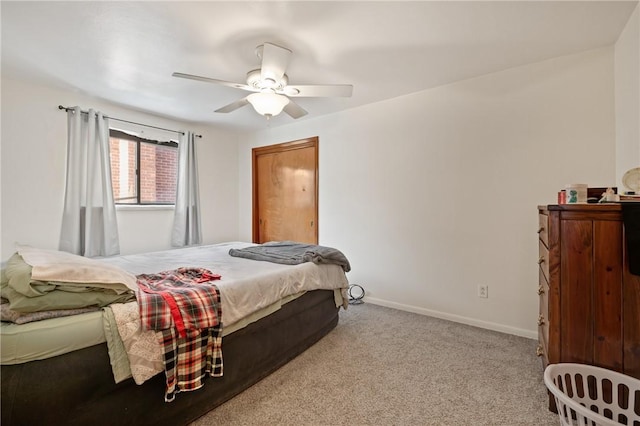 bedroom featuring light colored carpet and ceiling fan