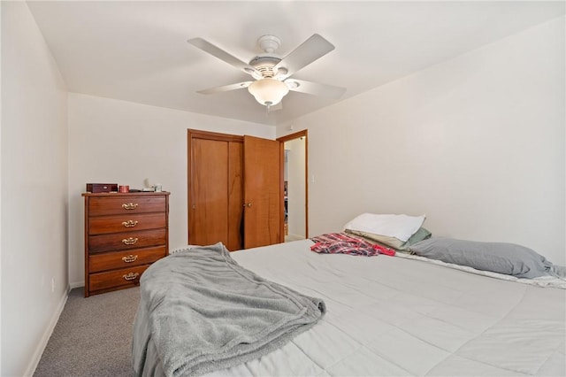 carpeted bedroom with ceiling fan and a closet