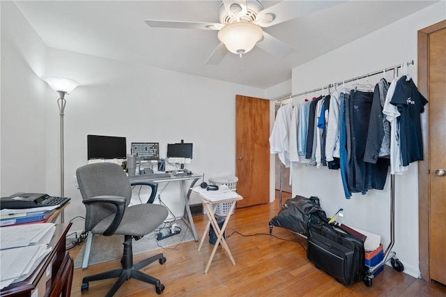 home office featuring wood-type flooring and ceiling fan