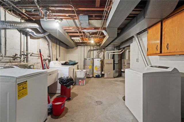 basement with heating unit, washing machine and dryer, and water heater