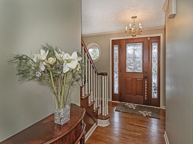 foyer featuring plenty of natural light, dark wood-type flooring, a notable chandelier, and a textured ceiling