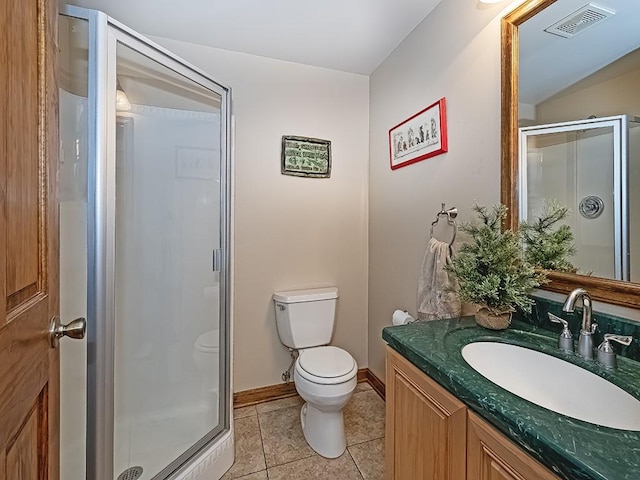 bathroom with vanity, toilet, tile patterned flooring, and a shower with door