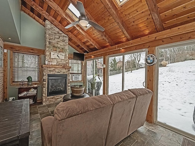 living room featuring high vaulted ceiling, a fireplace, beamed ceiling, ceiling fan, and wood ceiling