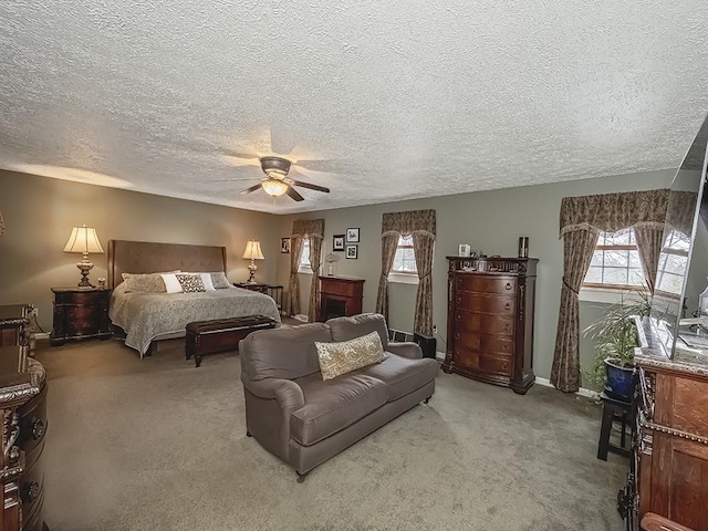 bedroom with a textured ceiling, carpet floors, and ceiling fan