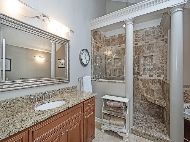 bathroom featuring ornate columns, vanity, and a shower with door