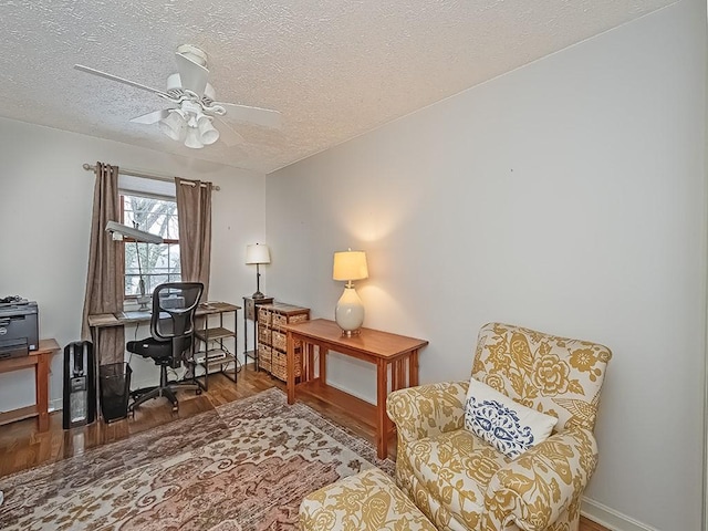 office featuring ceiling fan, hardwood / wood-style floors, and a textured ceiling