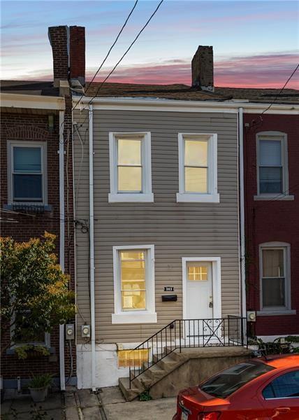 view of back house at dusk