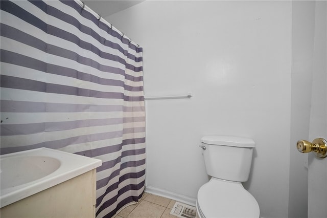 bathroom featuring tile patterned flooring, vanity, and toilet